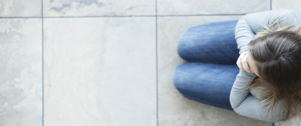 Woman praying on rug