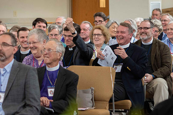 Clergy and delegates laughingh