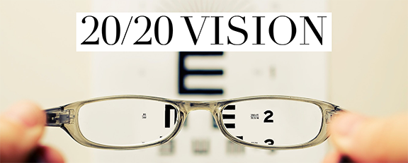 Glasses with eye exam chart and 20/20 Vision