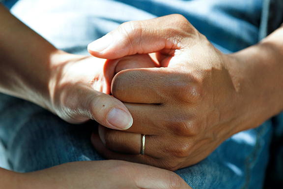 Patient holding hands