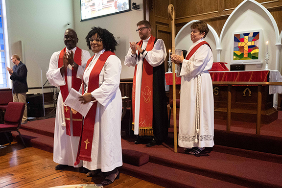 Henrietta Rivers stands in front after ordination