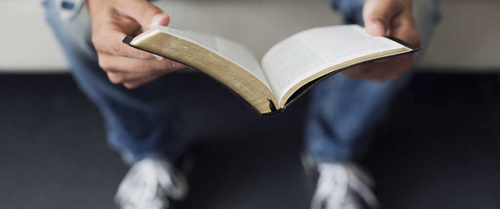 Teen boy reading Bible